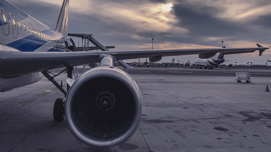 A close of of an aircarft wing and the engine